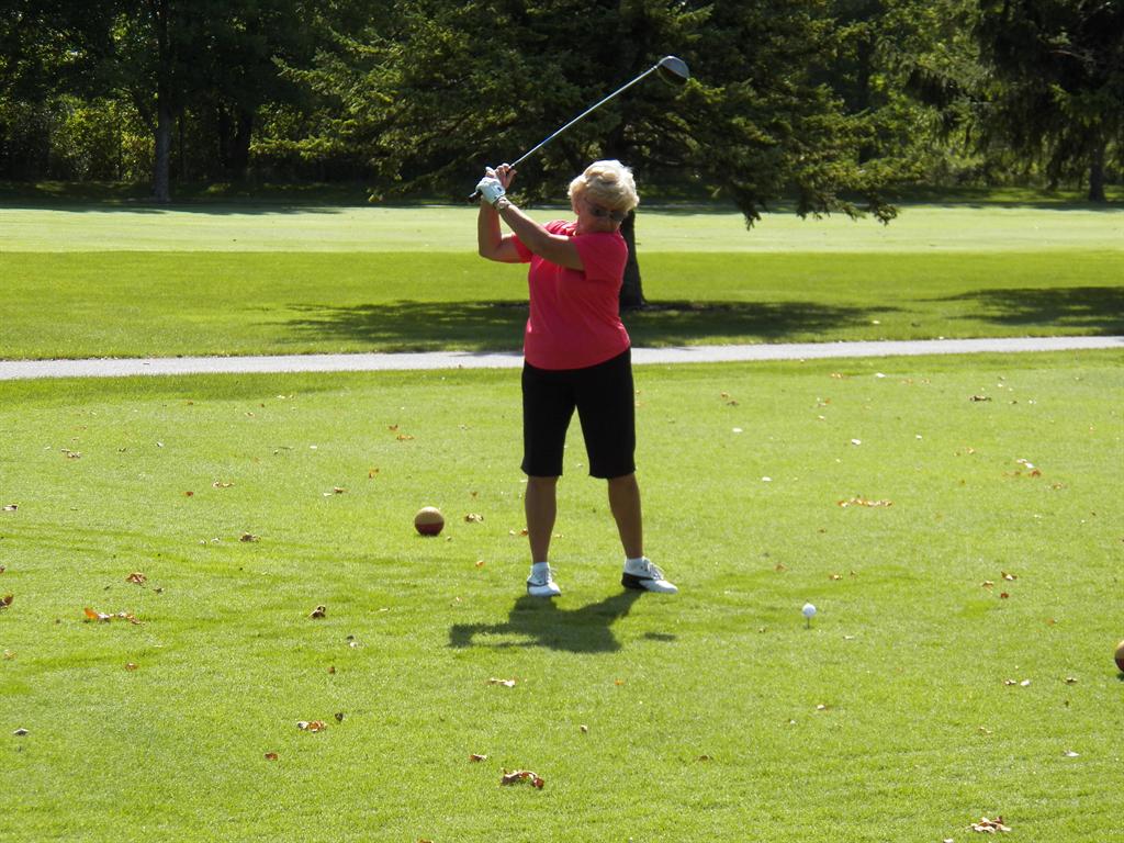 Marilyn Hubert puts a smooth swing on her tee shot on #15.